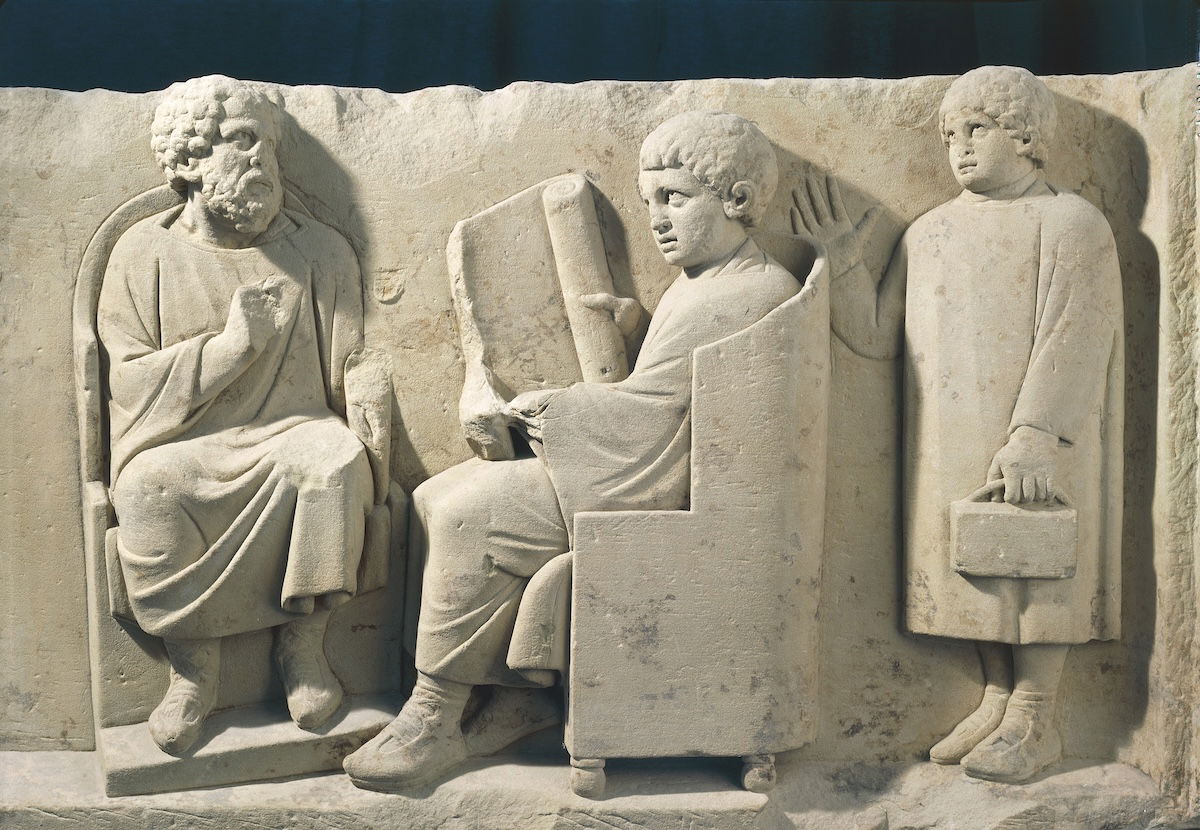 Relief from a burial monument showing a teacher and students, Neumagen, Germany, c.AD 180. G. Dagli Orti/NPL - DeA Picture Library/Bridgeman Images.
